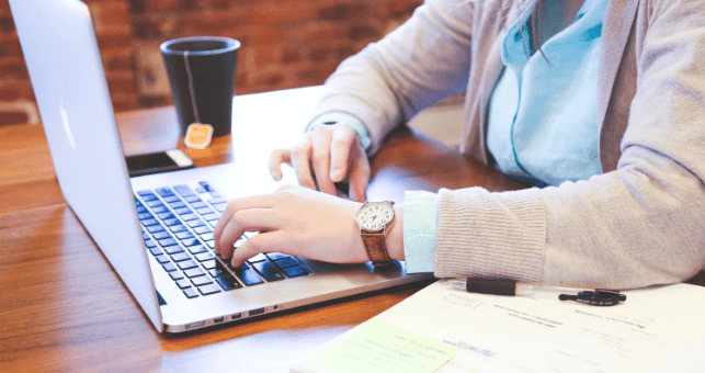 women typing on laptop